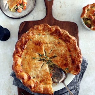 A rustic vegetarian pot pie loaded with hearty veggies coated in a creamy gravy, and tucked in between two crunchy flaky pie crusts.