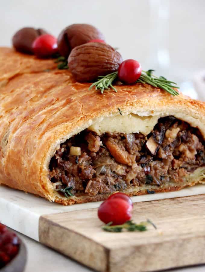Vegetarian mushroom wellington is prepared with a simple thyme mushroom-chestnut filling wrapped inside a flaky puff pastry.