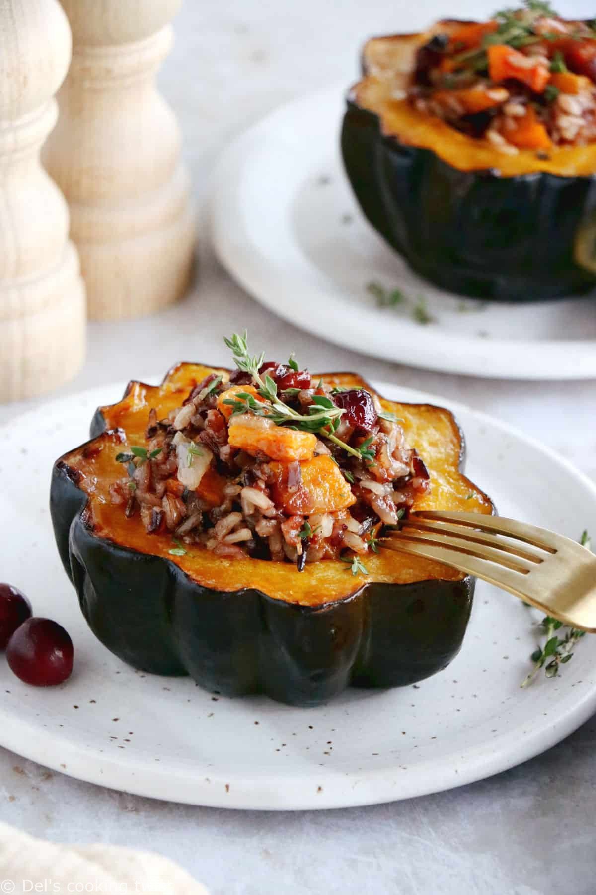 Wild rice stuffed acorn squash is an easy, healthy and nutritious vegetarian dish featuring roasted acorn squash halves filled with wild rice, mushrooms and cranberries.