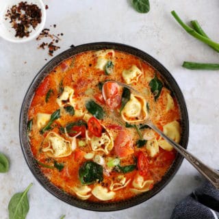Thai red curry tortellini soup is fusion food at its finest, resulting from Thai cuisine meeting the Italian one.