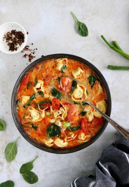 Thai red curry tortellini soup is fusion food at its finest, resulting from Thai cuisine meeting the Italian one.