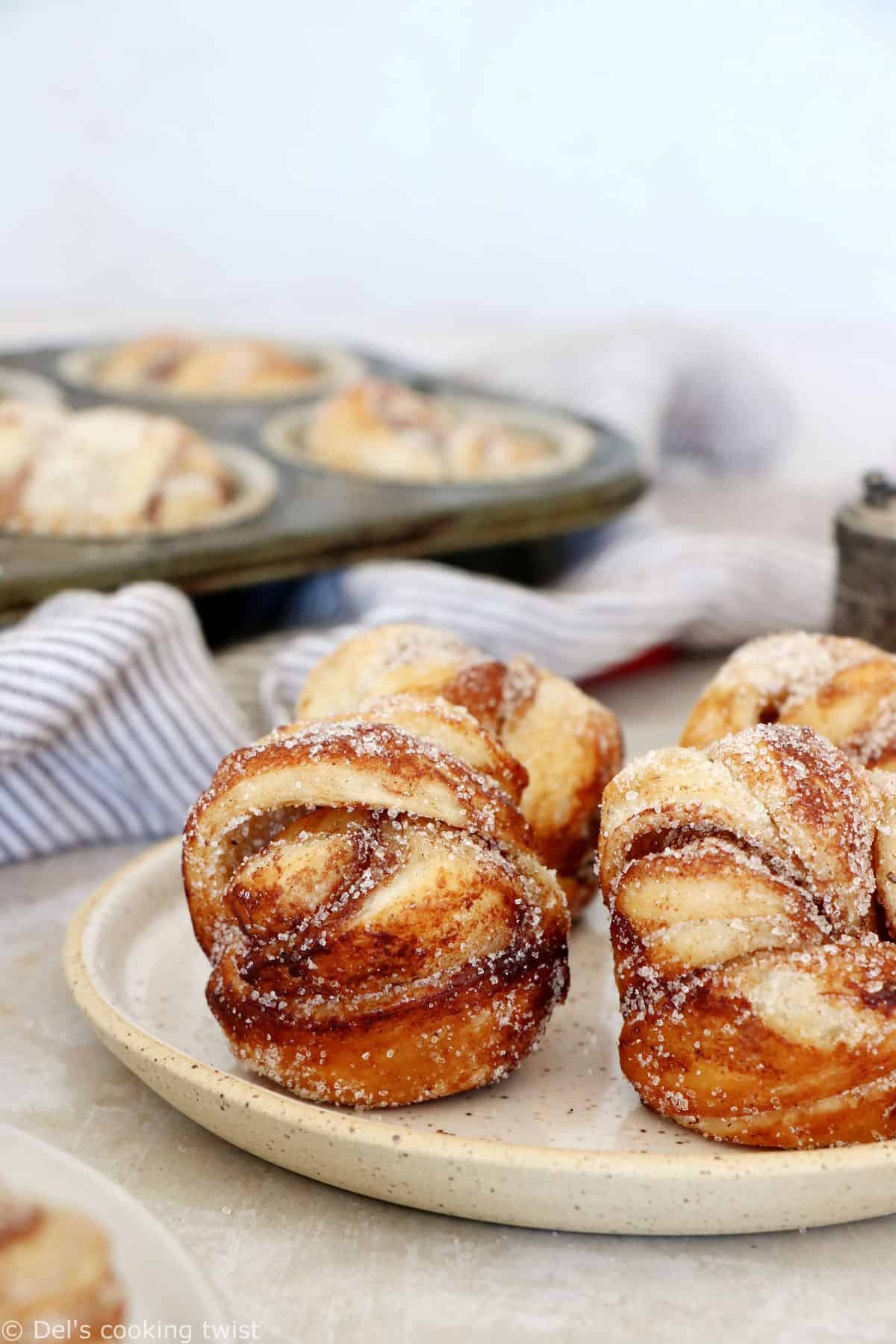 This easy cinnamon cardamom muffins recipe is a cross between a croissant and a muffin. In this easy version, the croissant dough is replaced with puff pastry, filled with cinnamon and coated in a cardamon-sugar mixture.