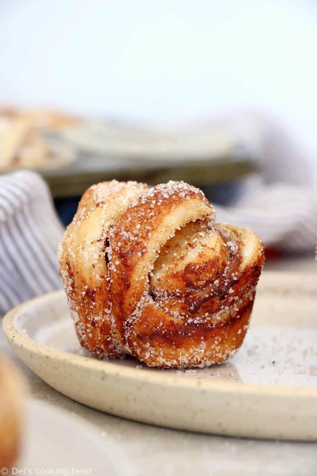 This easy cinnamon cardamom muffins recipe is a cross between a croissant and a muffin. In this easy version, the croissant dough is replaced with puff pastry, filled with cinnamon and coated in a cardamon-sugar mixture.