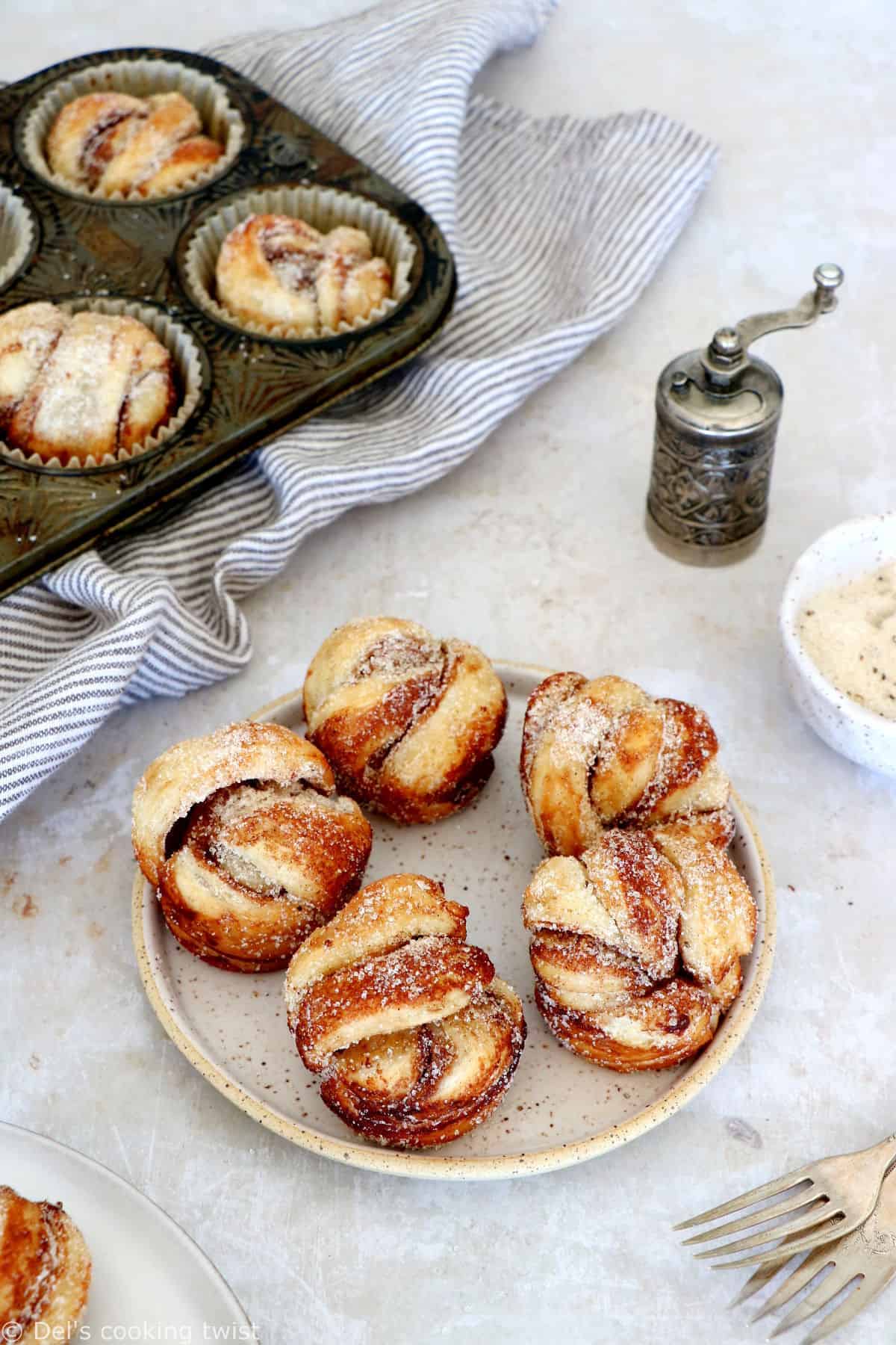 This easy cinnamon cardamom muffins recipe is a cross between a croissant and a muffin. In this easy version, the croissant dough is replaced with puff pastry, filled with cinnamon and coated in a cardamon-sugar mixture.