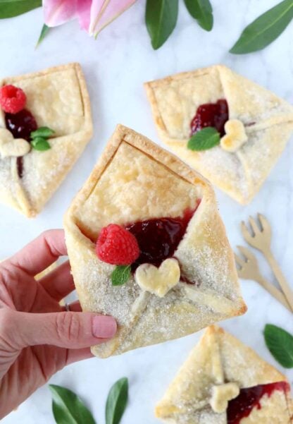 These adorable raspberry pie pastry envelopes are mini pies folded like an envelope, and filled with a delicious raspberry jam.