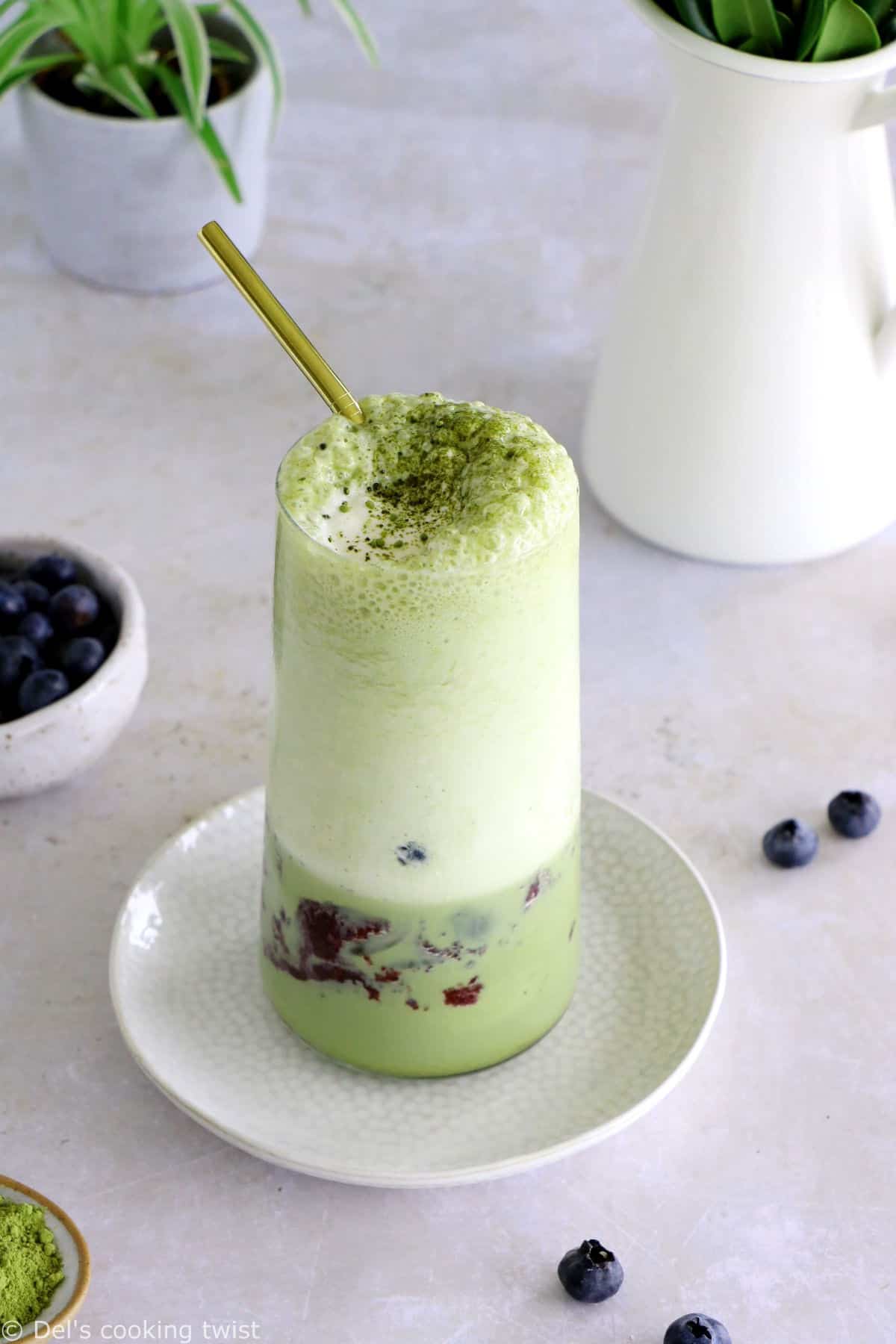 Matcha frappuccino is easy to make in a blender in just a few seconds. This frozen green tea latte is sweet and delicious, and even comes with a blueberry swirl bottom.