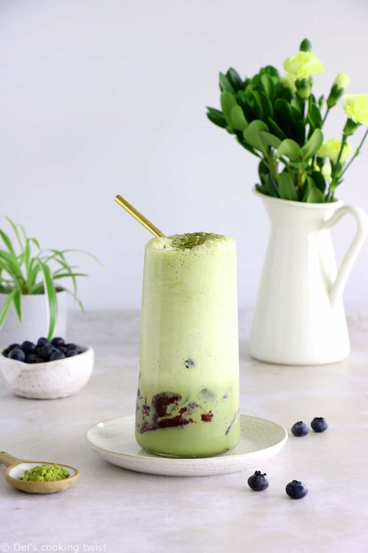 Matcha frappuccino is easy to make in a blender in just a few seconds. This frozen green tea latte is sweet and delicious, and even comes with a blueberry swirl bottom.