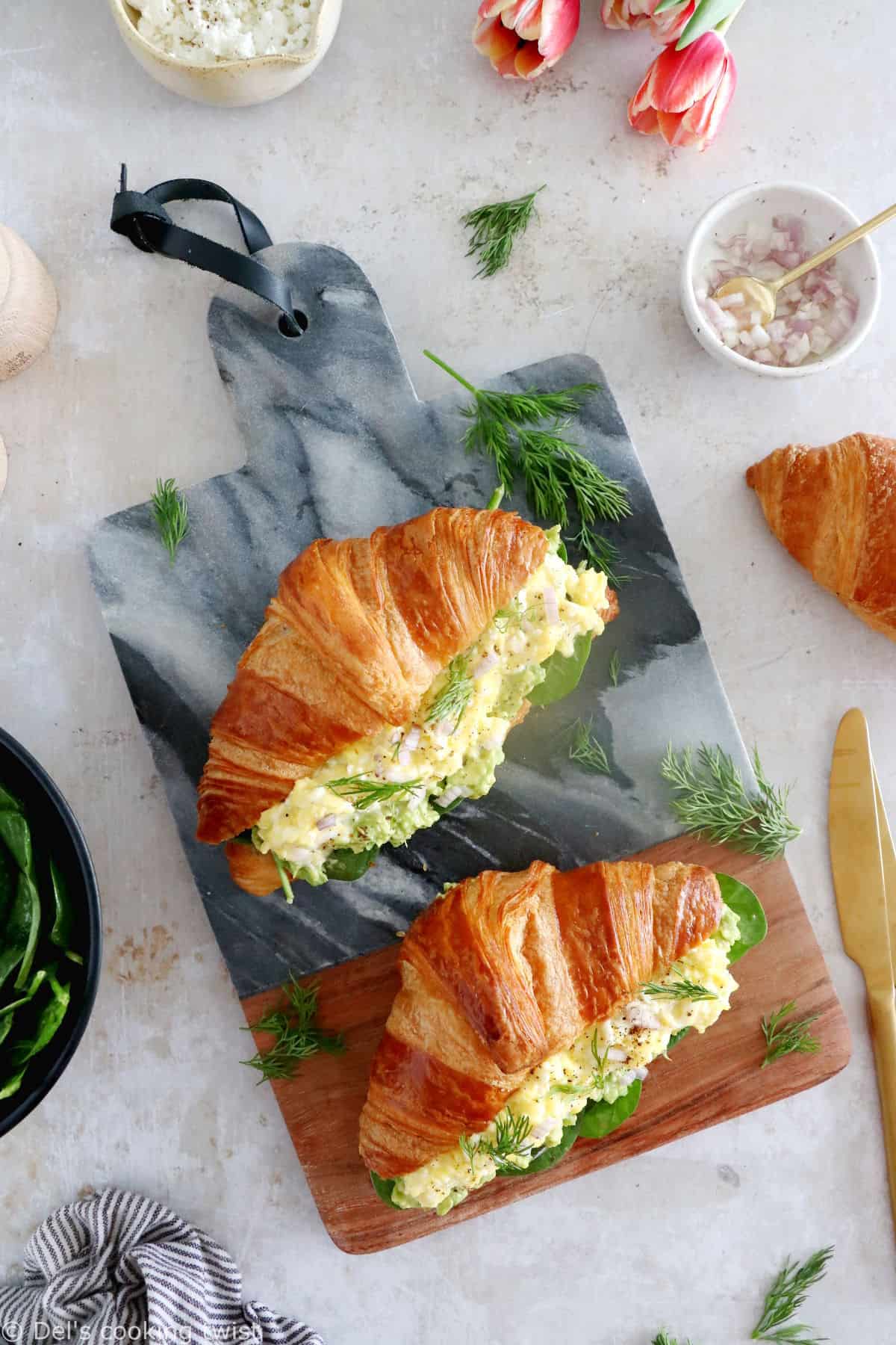 Scrambled egg croissant breakfast sandwiches are filled with avocado, goat cheese scrambled eggs and baby spinach. A great lazy breakfast.
