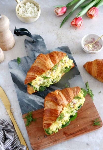 Scrambled egg croissant breakfast sandwiches are filled with avocado, goat cheese scrambled eggs and baby spinach. A great lazy breakfast.