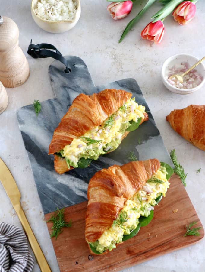 Scrambled egg croissant breakfast sandwiches are filled with avocado, goat cheese scrambled eggs and baby spinach. A great lazy breakfast.