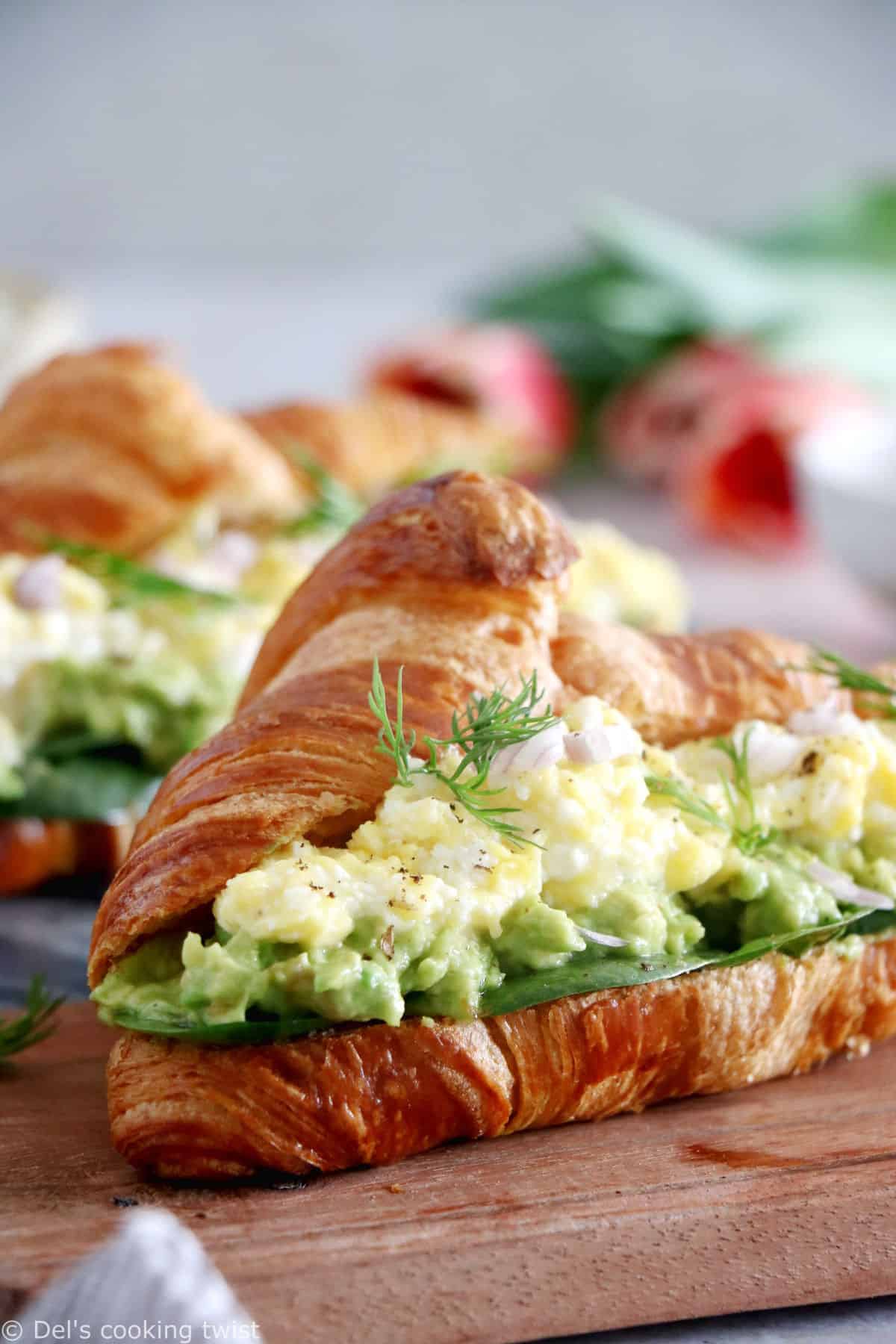 Scrambled egg croissant breakfast sandwiches are filled with avocado, goat cheese scrambled eggs and baby spinach. A great lazy breakfast.