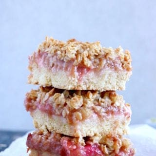 Rhubarb Crumble Bars are a must bake summer dessert recipe. They feature a thick and generous base, a juicy, sweet and tart rhubarb compote, and a crispy oat crumble on top.