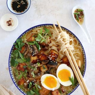 Here's a delicious tahini miso ramen with crispy tofu, sautéed mushrooms, soft boiled eggs, and a broth loaded with umami and slightly spicy flavors.