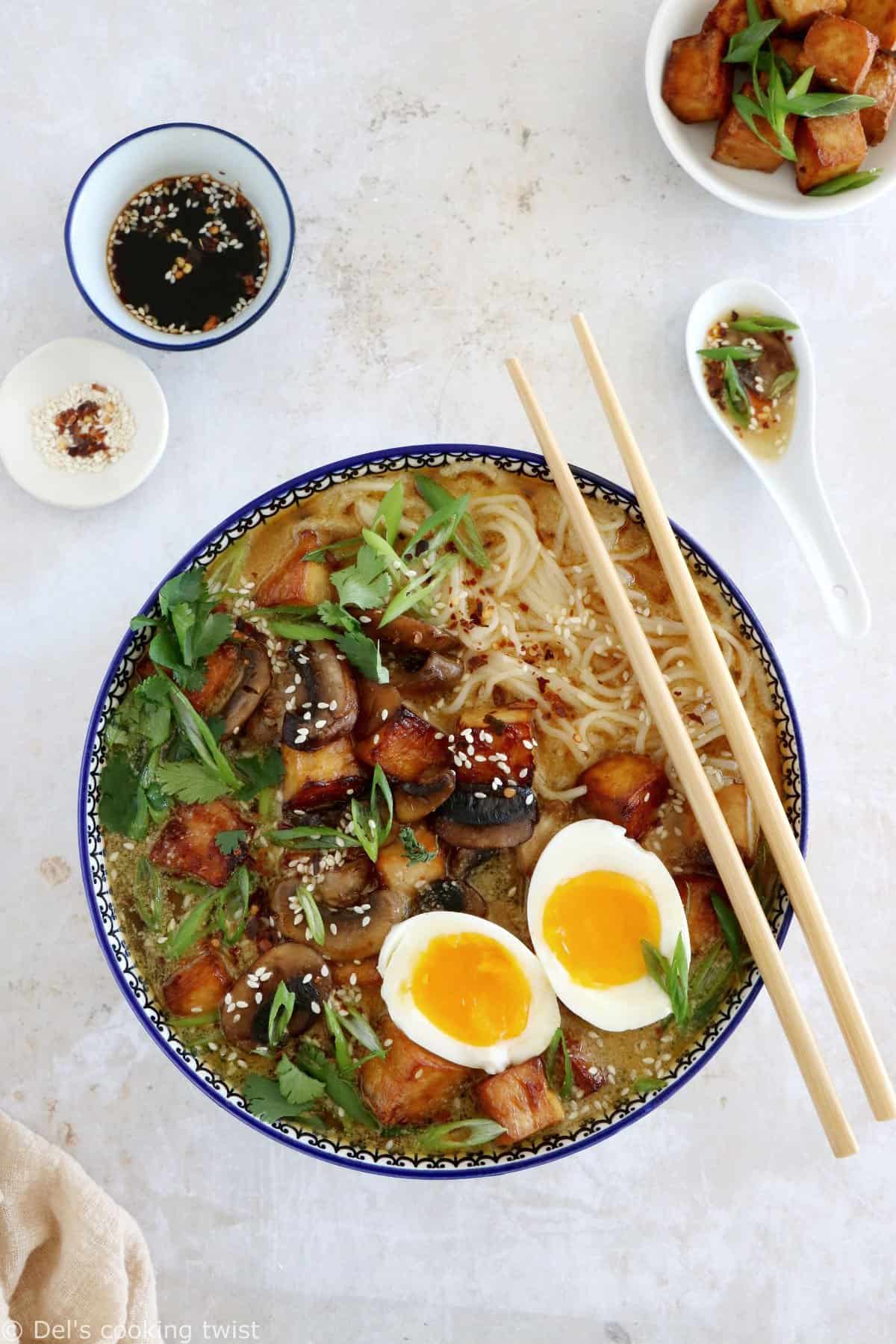 Here's a delicious tahini miso ramen with crispy tofu, sautéed mushrooms, soft boiled eggs, and a broth loaded with umami and slightly spicy flavors.