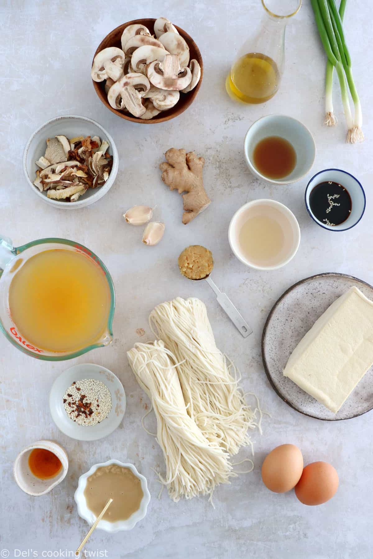 Here's a delicious tahini miso ramen with crispy tofu, sautéed mushrooms, soft boiled eggs, and a broth loaded with umami and slightly spicy flavors.