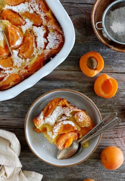 Apricot clafoutis is a timeless French dessert, consisting of a simple creamy custard base filled with fresh apricots.