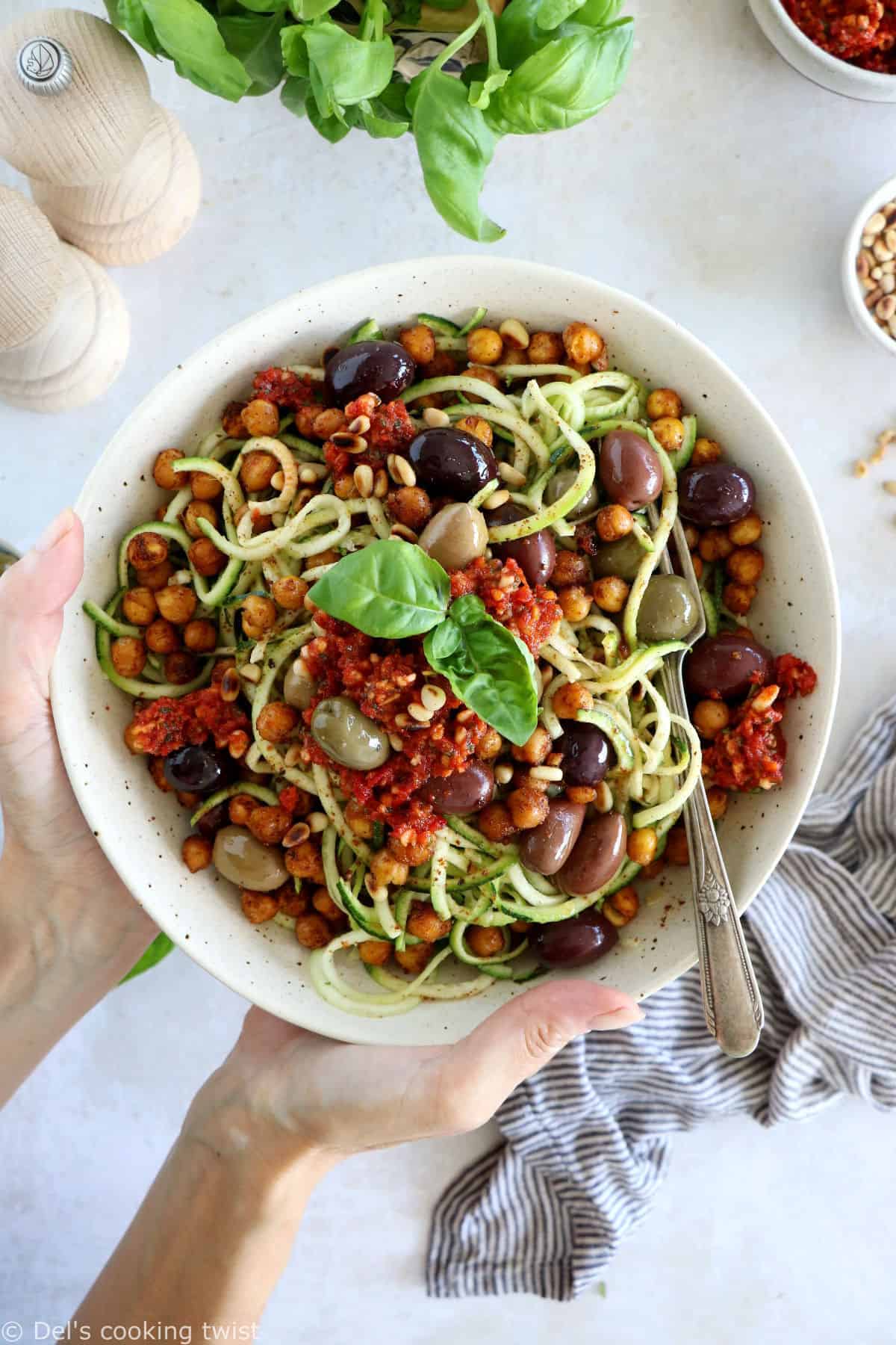 These Mediterranean chickpea zoodles burst with summer flavors. Both vegan and gluten-free, this healthy dish features some zucchini noodles, olives and roasted chickpeas, tossed in a delicious homemade sun-dried tomato sauce.