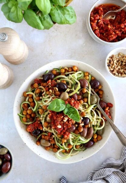 These Mediterranean chickpea zoodles burst with summer flavors. Both vegan and gluten-free, this healthy dish features some zucchini noodles, olives and roasted chickpeas, tossed in a delicious homemade sun-dried tomato sauce.