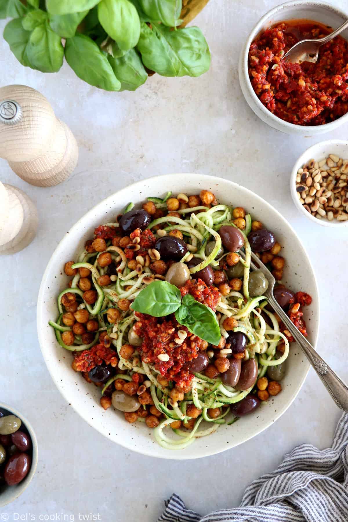 These Mediterranean chickpea zoodles burst with summer flavors. Both vegan and gluten-free, this healthy dish features some zucchini noodles, olives and roasted chickpeas, tossed in a delicious homemade sun-dried tomato sauce.