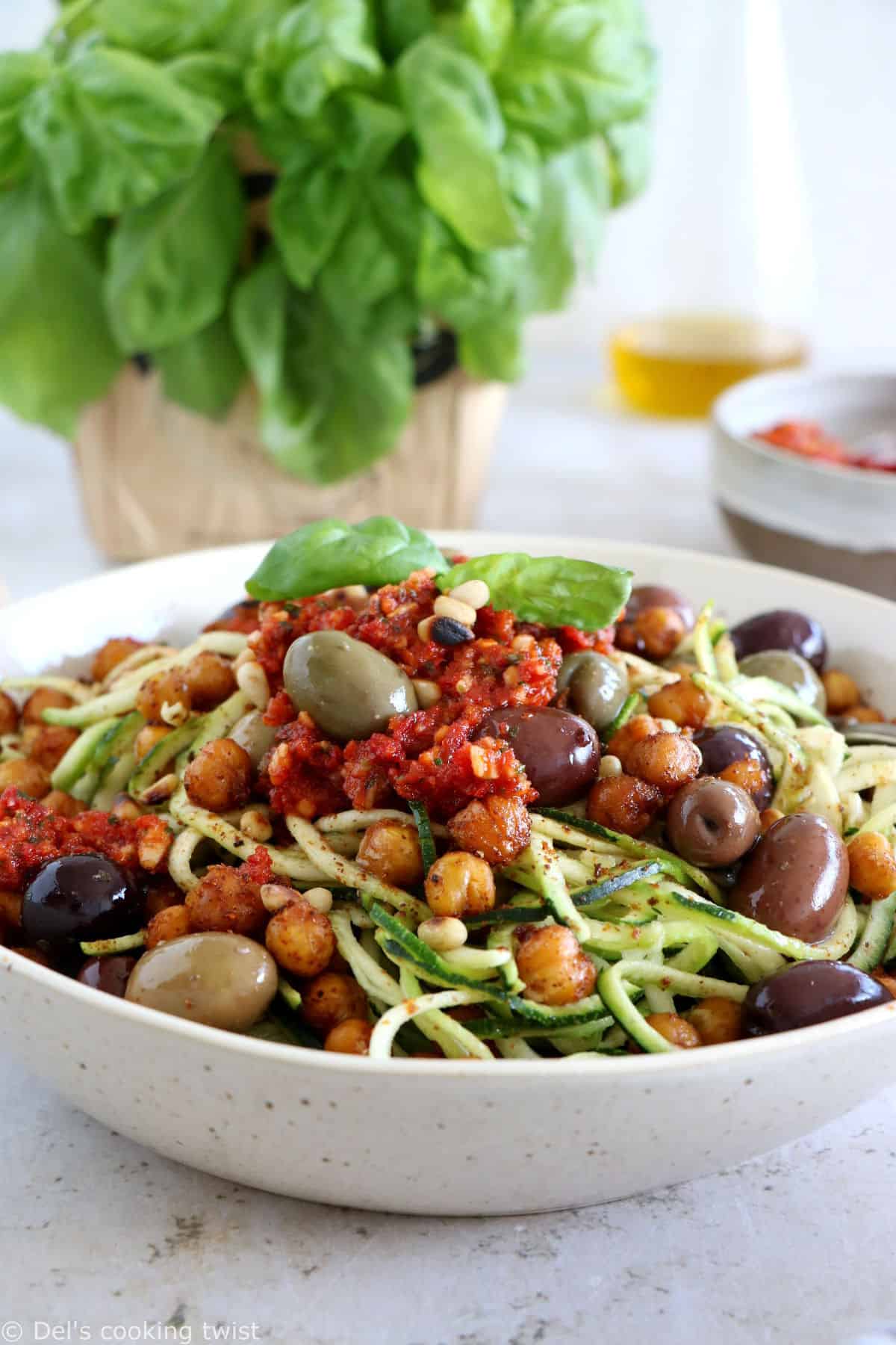 These Mediterranean chickpea zoodles burst with summer flavors. Both vegan and gluten-free, this healthy dish features some zucchini noodles, olives and roasted chickpeas, tossed in a delicious homemade sun-dried tomato sauce.