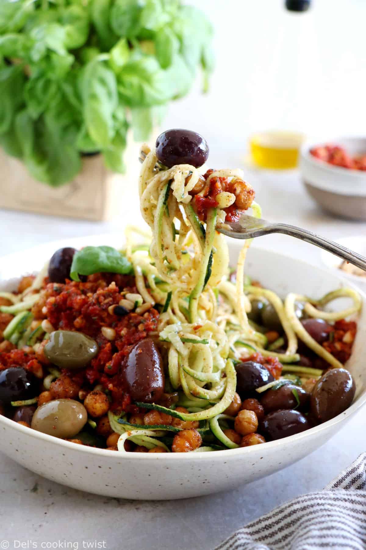 These Mediterranean chickpea zoodles burst with summer flavors. Both vegan and gluten-free, this healthy dish features some zucchini noodles, olives and roasted chickpeas, tossed in a delicious homemade sun-dried tomato sauce.