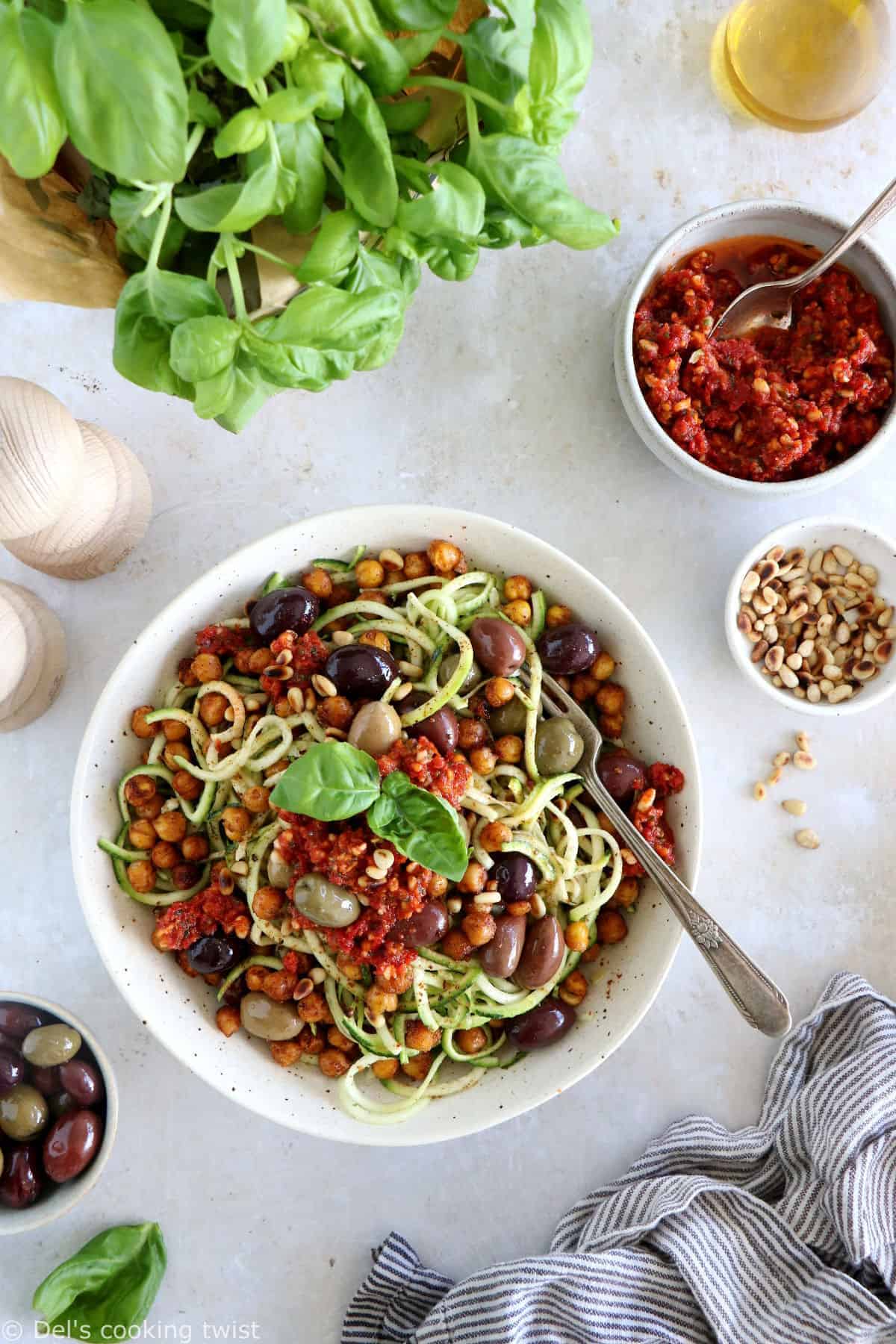 These Mediterranean chickpea zoodles burst with summer flavors. Both vegan and gluten-free, this healthy dish features some zucchini noodles, olives and roasted chickpeas, tossed in a delicious homemade sun-dried tomato sauce.