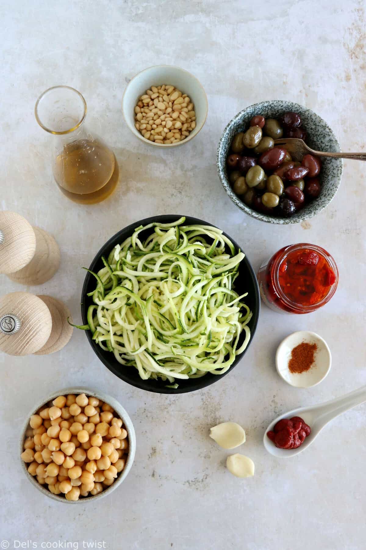 These Mediterranean chickpea zoodles burst with summer flavors. Both vegan and gluten-free, this healthy dish features some zucchini noodles, olives and roasted chickpeas, tossed in a delicious homemade sun-dried tomato sauce.