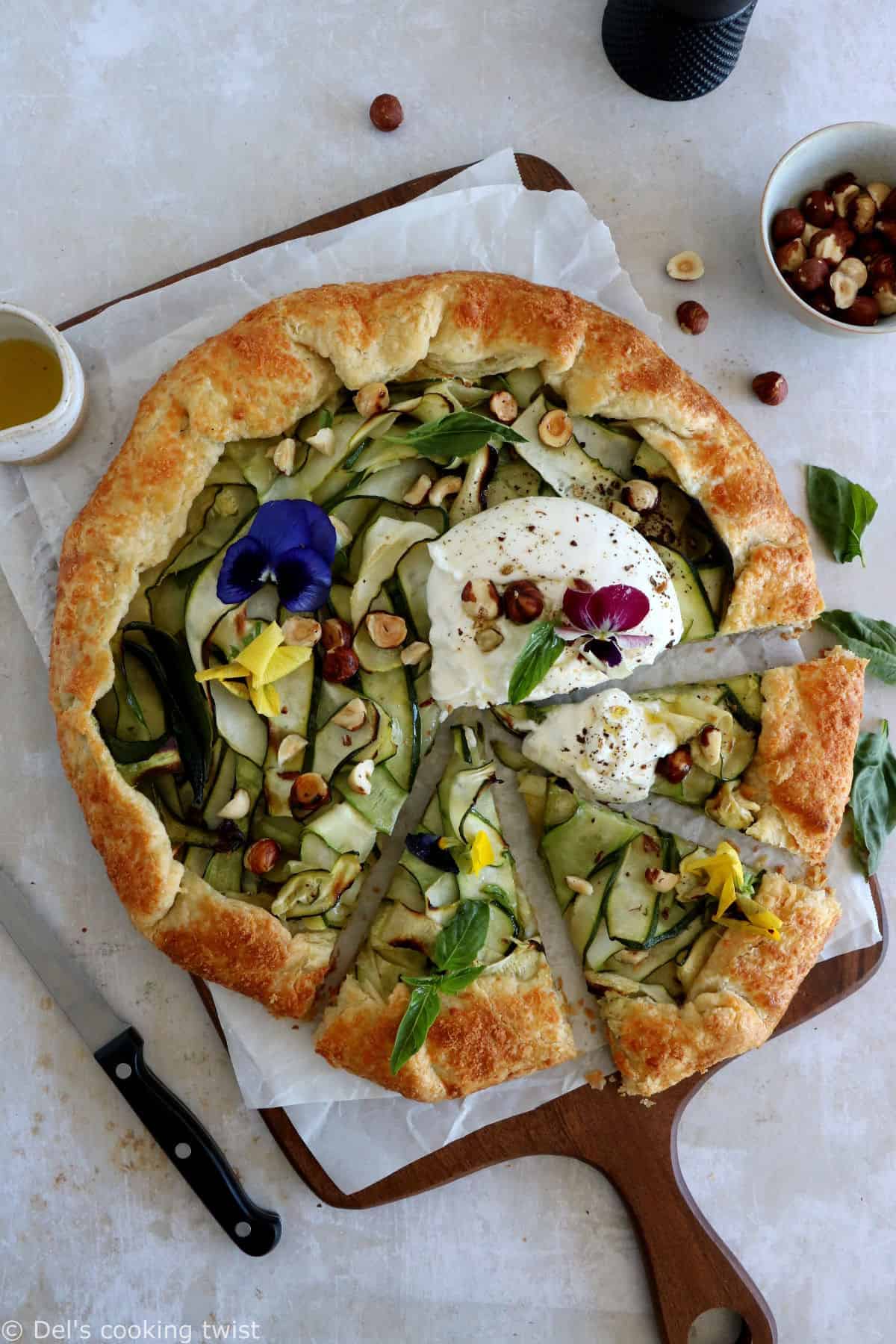 This beautiful zucchini galette is prepared with honey zucchini ribbons, toasted hazelnuts, and some burrata cheese bursting with refreshing flavors.