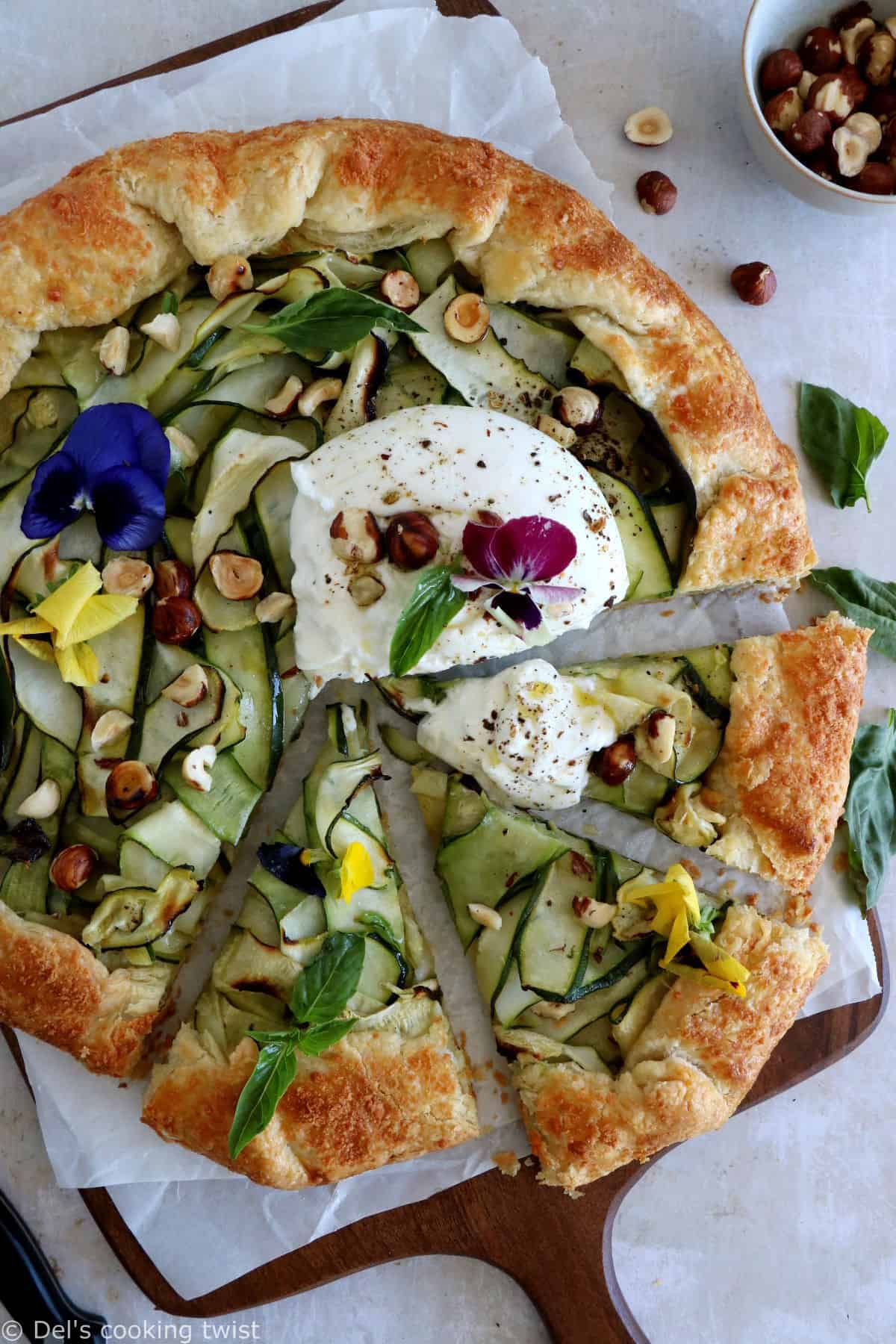 This beautiful zucchini galette is prepared with honey zucchini ribbons, toasted hazelnuts, and some burrata cheese bursting with refreshing flavors.