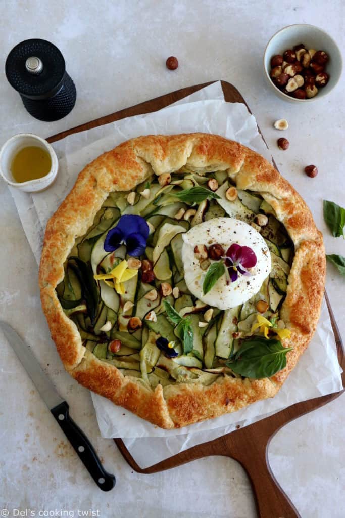 This beautiful zucchini galette is prepared with honey zucchini ribbons, toasted hazelnuts, and some burrata cheese bursting with refreshing flavors.