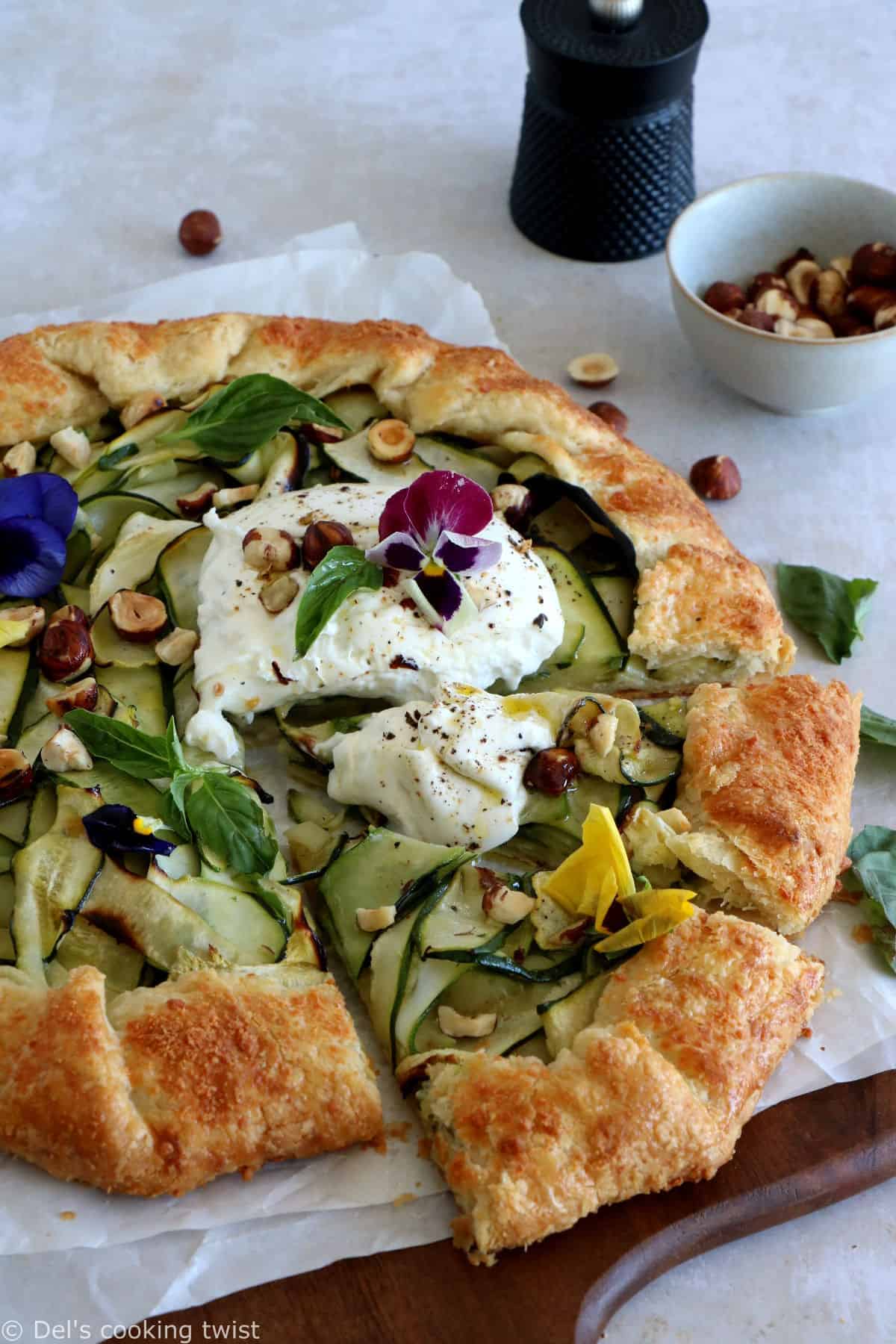 This beautiful zucchini galette is prepared with honey zucchini ribbons, toasted hazelnuts, and some burrata cheese bursting with refreshing flavors.