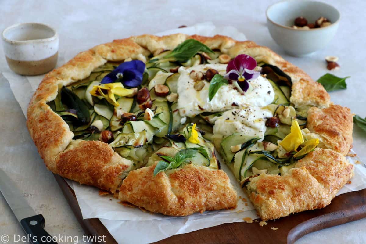 This beautiful zucchini galette is prepared with honey zucchini ribbons, toasted hazelnuts, and some burrata cheese bursting with refreshing flavors.