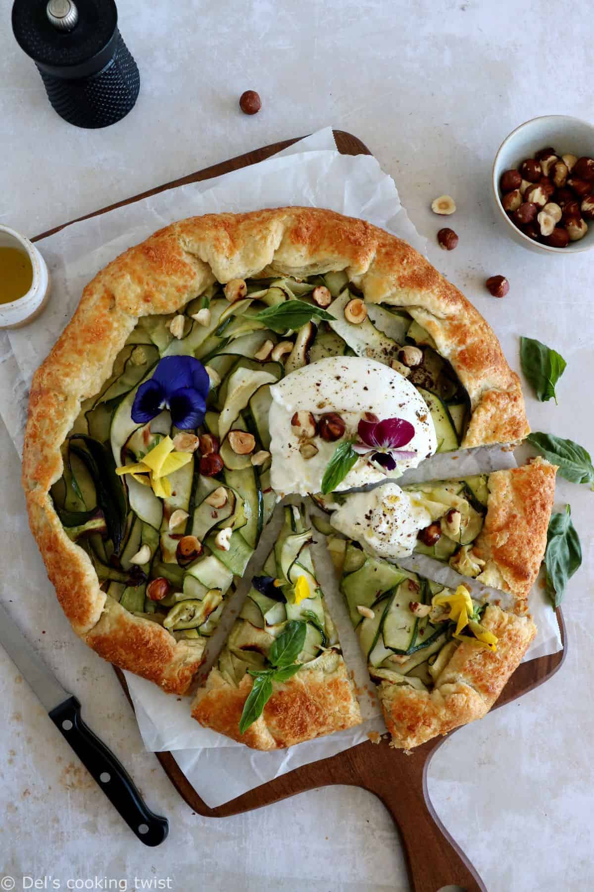 This beautiful zucchini galette is prepared with honey zucchini ribbons, toasted hazelnuts, and some burrata cheese bursting with refreshing flavors.