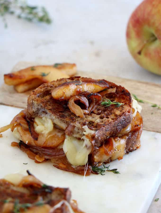Apple and French Onion Grilled Cheese is a gourmet grilled cheese sandwich prepared with cheddar, caramelized onions and some cooked apples.