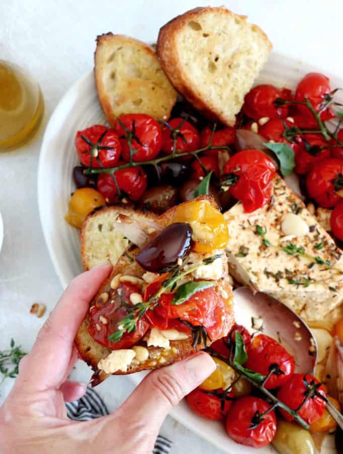 This baked feta with cherry tomatoes and olives, tossed with olive oil, herbs and various seasoning, is bursting with juicy and cheesy flavors.
