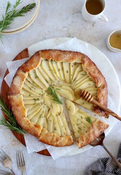 This rosemary honey pear galette is an easy pear tart recipe, featuring an irresistible flaky crust and some juicy pears infused in a rosemary honey syrup.