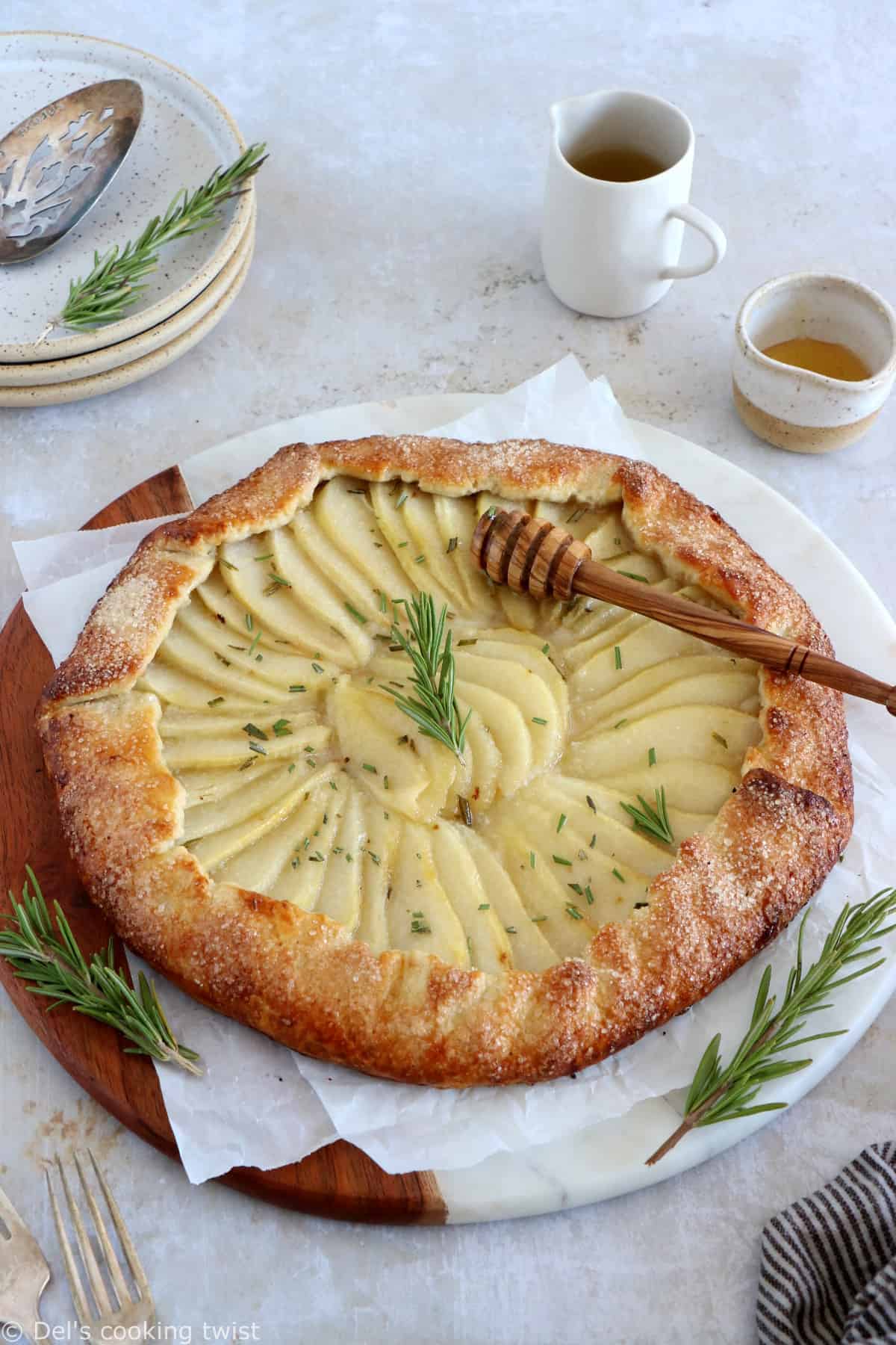 This rosemary honey pear galette is an easy pear tart recipe, featuring an irresistible flaky crust and some juicy pears infused in a rosemary honey syrup.