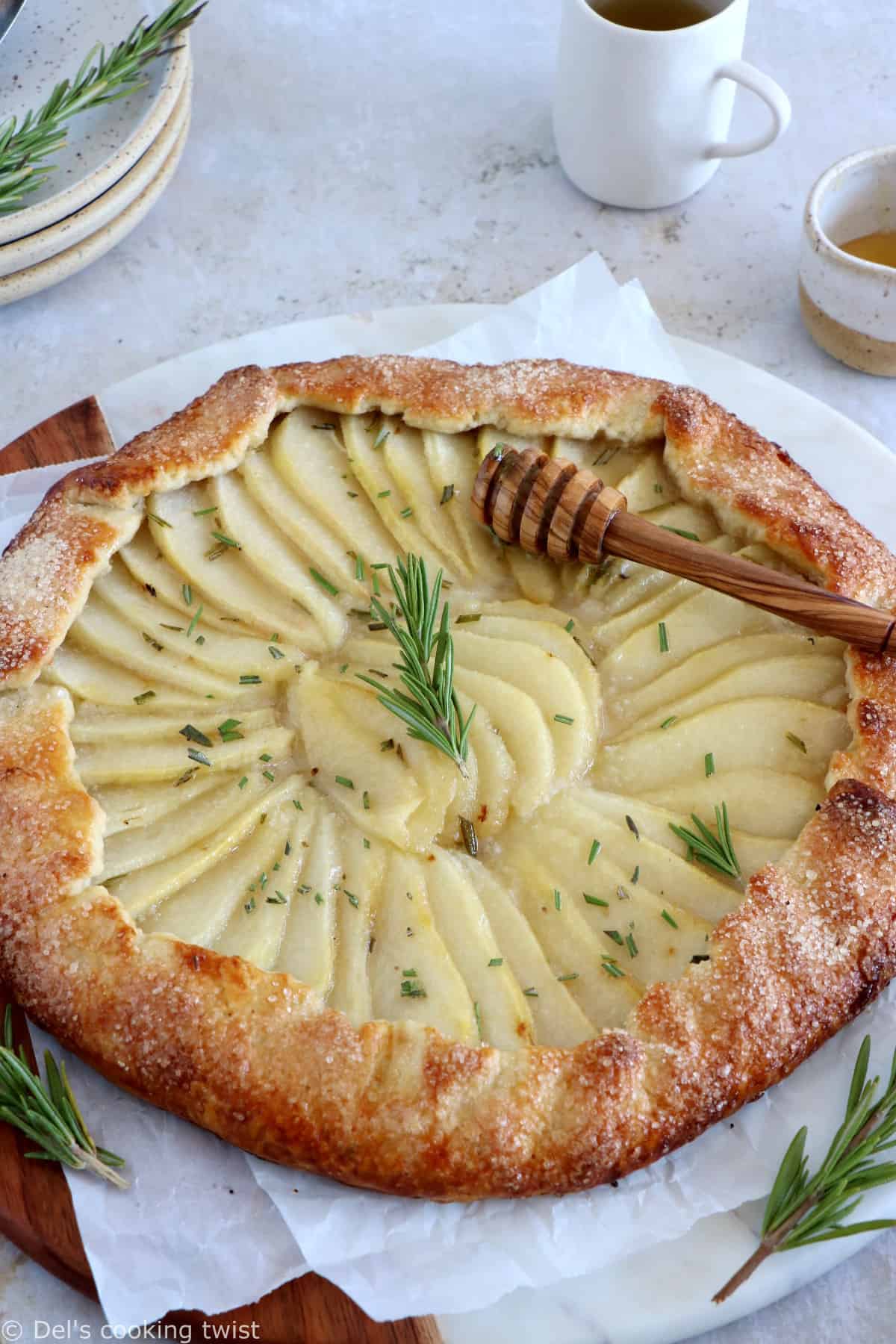 This rosemary honey pear galette is an easy pear tart recipe, featuring an irresistible flaky crust and some juicy pears infused in a rosemary honey syrup.