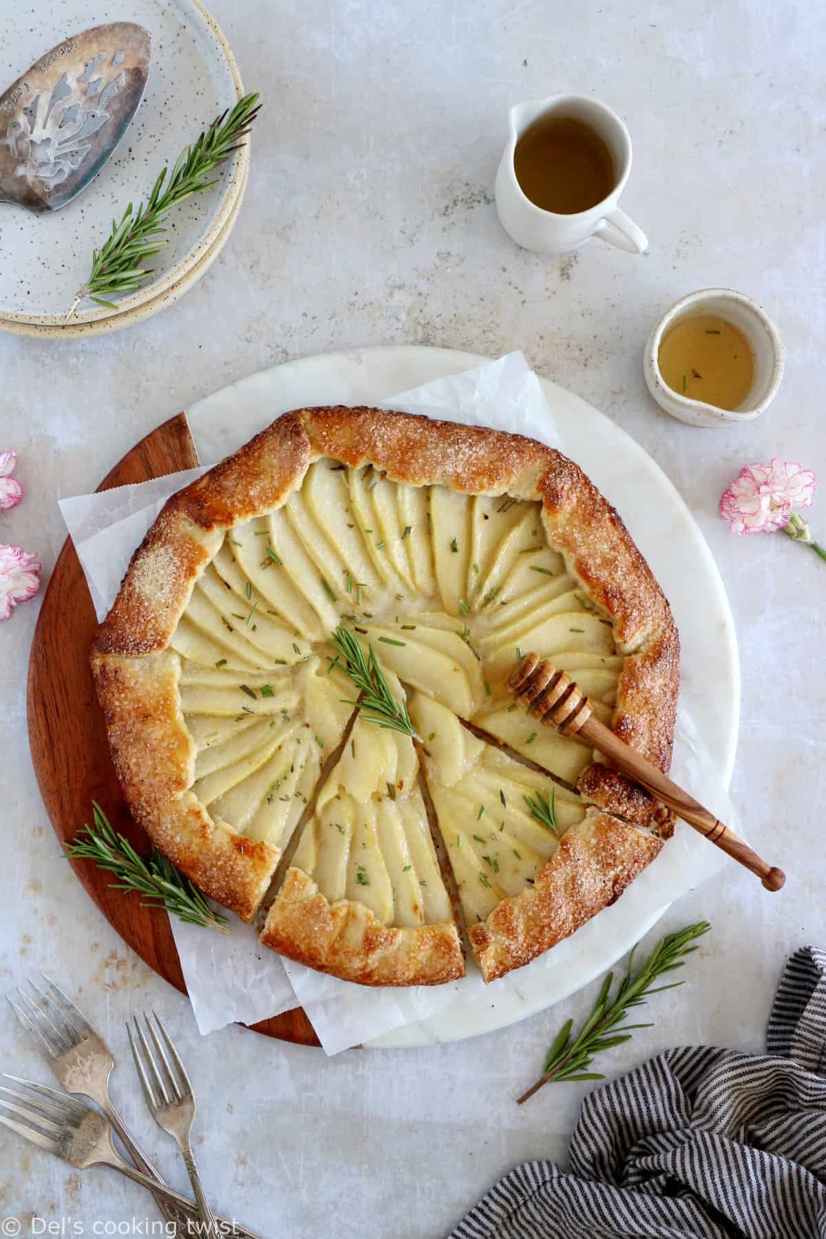 This rosemary honey pear galette is an easy pear tart recipe, featuring an irresistible flaky crust and some juicy pears infused in a rosemary honey syrup.