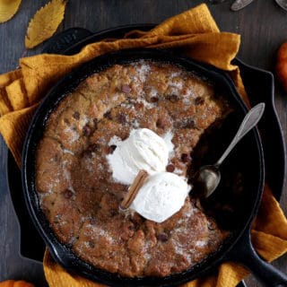 This pumpkin skillet cookie is rich, incredibly fudgy, loaded with chocolate chips and pumpkin spice flavors.