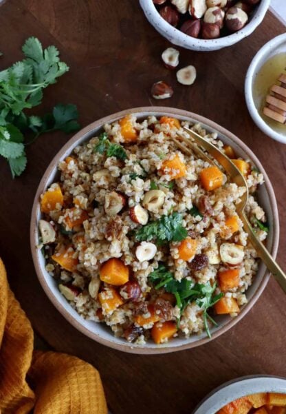 Butternut squash tabbouleh is prepared with bulgur, raisins, crunchy hazelnuts and fresh cilantro, generously coated in a honey vinaigrette.