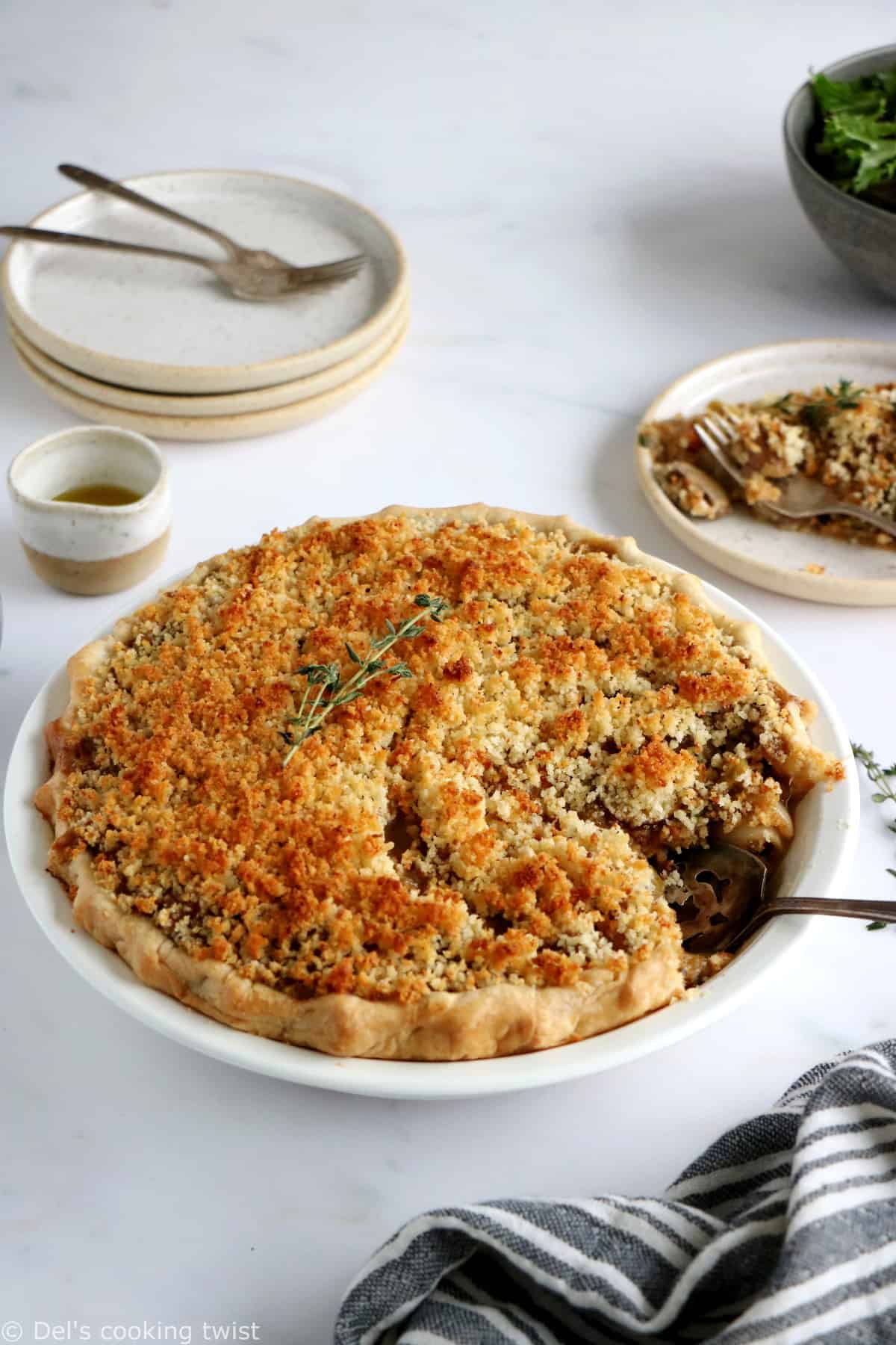 This vegetarian pot pie with crumble topping features some leek, shallots and mushrooms deglazed with white wine, and then coated in a creamy bechamel sauce.