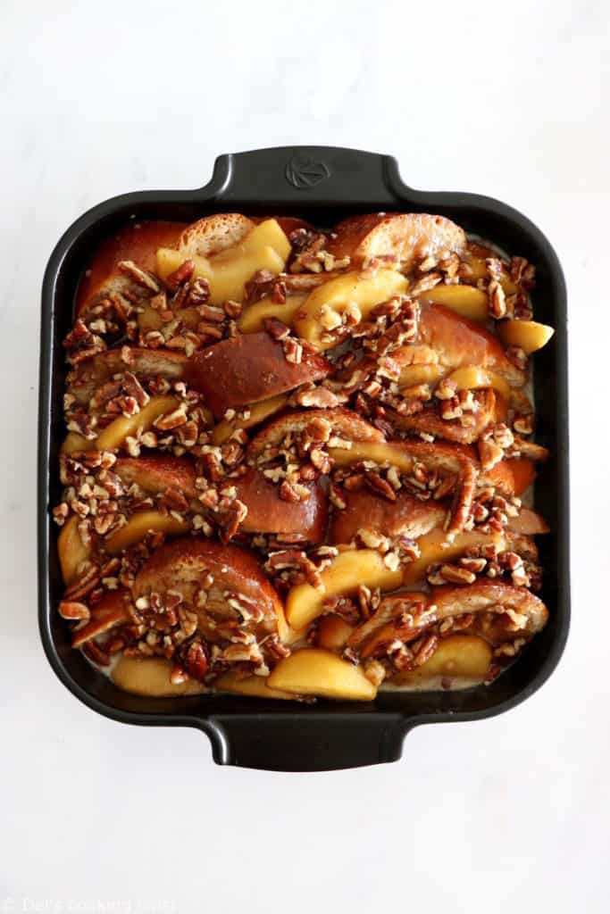 Baked Apple Pecan French Toast is the ultimate family breakfast, just perfect to feed a crowd. Both soft and crunchy, it features some thick challah bread slices, baked apples with a splash of whiskey, and an irresistible pecan-sugar mixture.