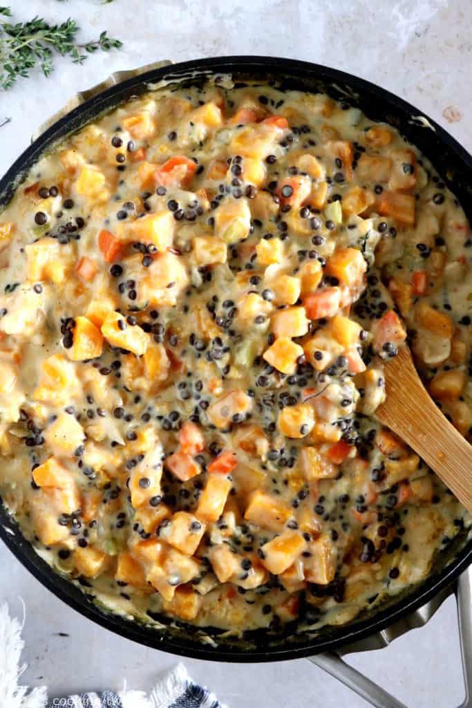 This butternut squash and lentil pot pie is prepared with a hearty and creamy vegetable filling, tucked into two homemade pie crusts.