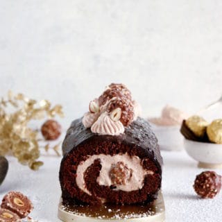 Ferrero Rocher Cake Roll consists in a chocolate sponge cake, a creamy chocolate-hazelnut mascarpone filling hiding some whole Ferrero Rochers, and a crispy Rocher chocolate coating on top.