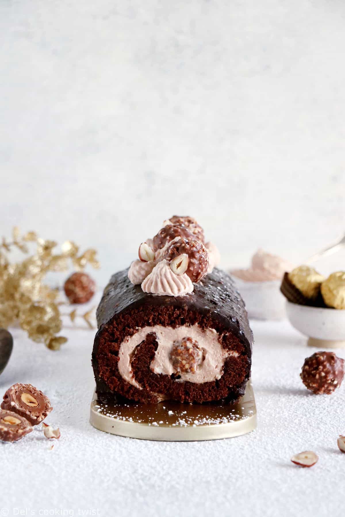 Ferrero Rocher Cake Roll consists in a chocolate sponge cake, a creamy chocolate-hazelnut mascarpone filling hiding some whole Ferrero Rochers, and a crispy Rocher chocolate coating on top.