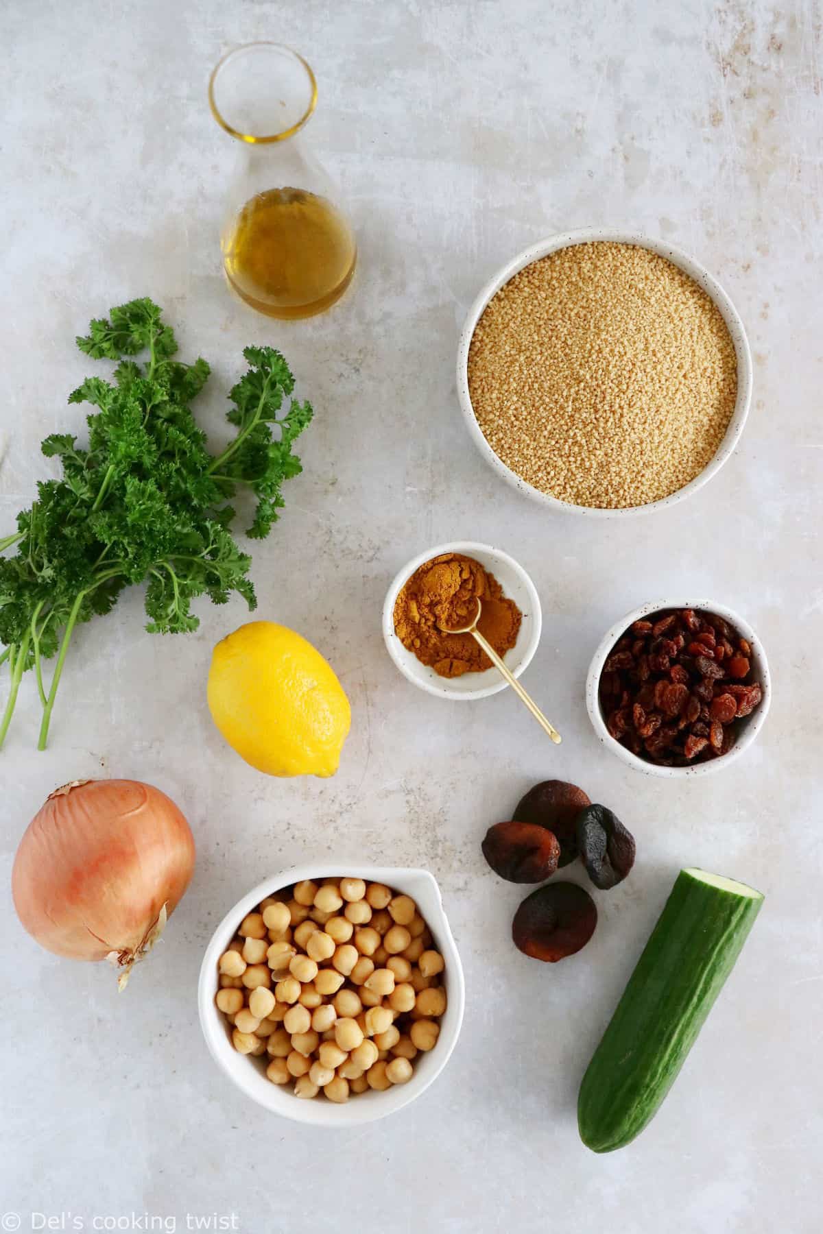 This Moroccan-inspired chickpea couscous salad consists in a delicious couscous flavored with ras el hanout, golden raisins, chickpeas and fresh herbs.