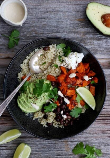 Sweet potato black bean quinoa bowl with tahini dressing makes a nourishing, healthy vegan meal loaded with veggies and plant-based protein.