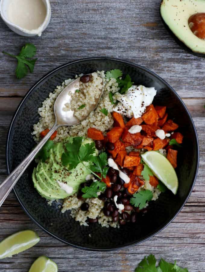 Sweet potato black bean quinoa bowl with tahini dressing makes a nourishing, healthy vegan meal loaded with veggies and plant-based protein.