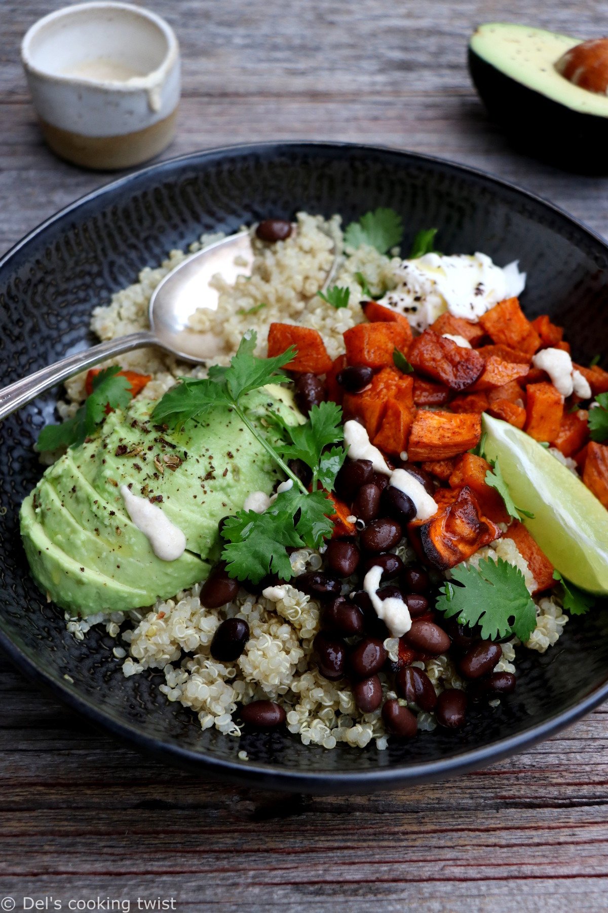 Sweet potato black bean quinoa bowl with tahini dressing makes a nourishing, healthy vegan meal loaded with veggies and plant-based protein.